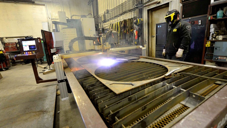 Welder wearing gloves, mask and protective clothing